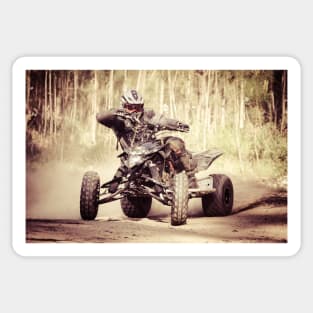 ATV racer takes a turn during a race. Sticker